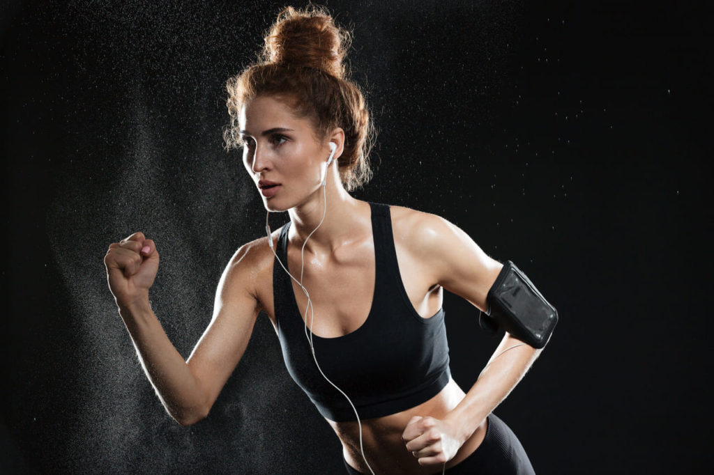 concentrated-fitness-woman-running-in-studio