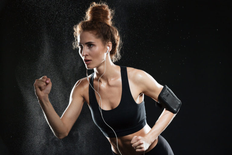 concentrated-fitness-woman-running-in-studio